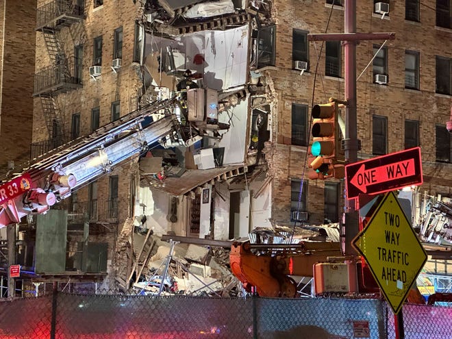 Firefighters continue to work the scene at a six-story corner of a Bronx apartment building that collapsed Monday, Dec. 11, 2023, in New York.